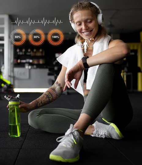 Fit woman relaxing after workout while checking health stats on smartwatch